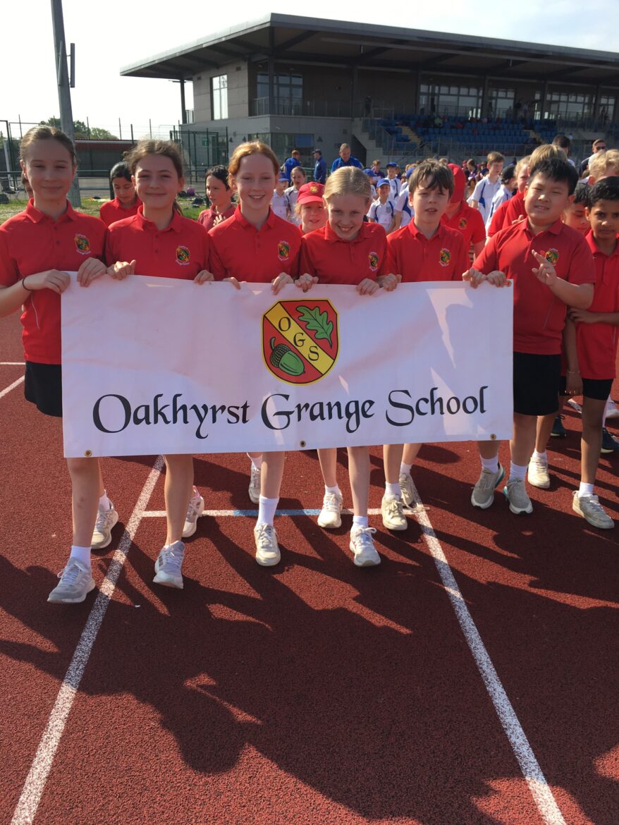 students holding a sign for Oakhyrst Grange school