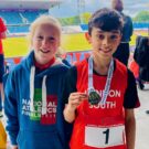 students holding medals