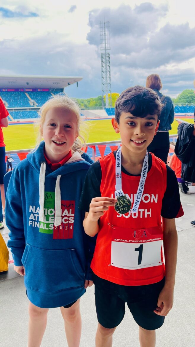 students holding medals